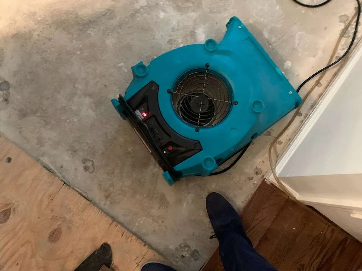 Air mover drying subfloor during Commercial Water Damage Restoration in Murphy